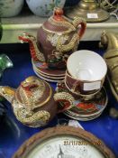 JAPANESE MADE TEA SET WITH DRAGON HANDLES AND FINIALS WITH ENAMELLED FIGURES