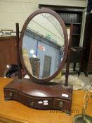 MAHOGANY FRAMED DRESSING TABLE MIRROR WITH THREE DRAWER SERPENTINE BASE AND AN OVAL MIRROR