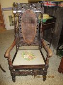 MADE FROM PERIOD TIMBERS HEAVILY CARVED ARMCHAIR WITH CANE BACK AND EMBROIDERED SEAT WITH CARVED