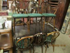 ERCOL RECTANGULAR DINING TABLE TOGETHER WITH A SET OF NINE ERCOL HARD SEATED DINING CHAIRS WITH
