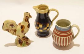 Wealden type pottery jug and Wealden style cockerel, together with a small ribbed mug, all with