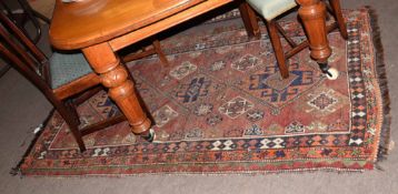 Caucasian wool carpet, central panel of three geometric large lozenges, mainly puce, rust and