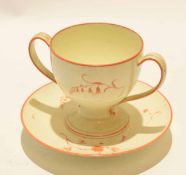 Wedgwood cream ware trembleuse cup and saucer with double loop handles and a sprigged design,
