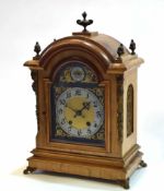 Early 20th century cast brass mounted walnut mantel clock, the arched case with overhanging