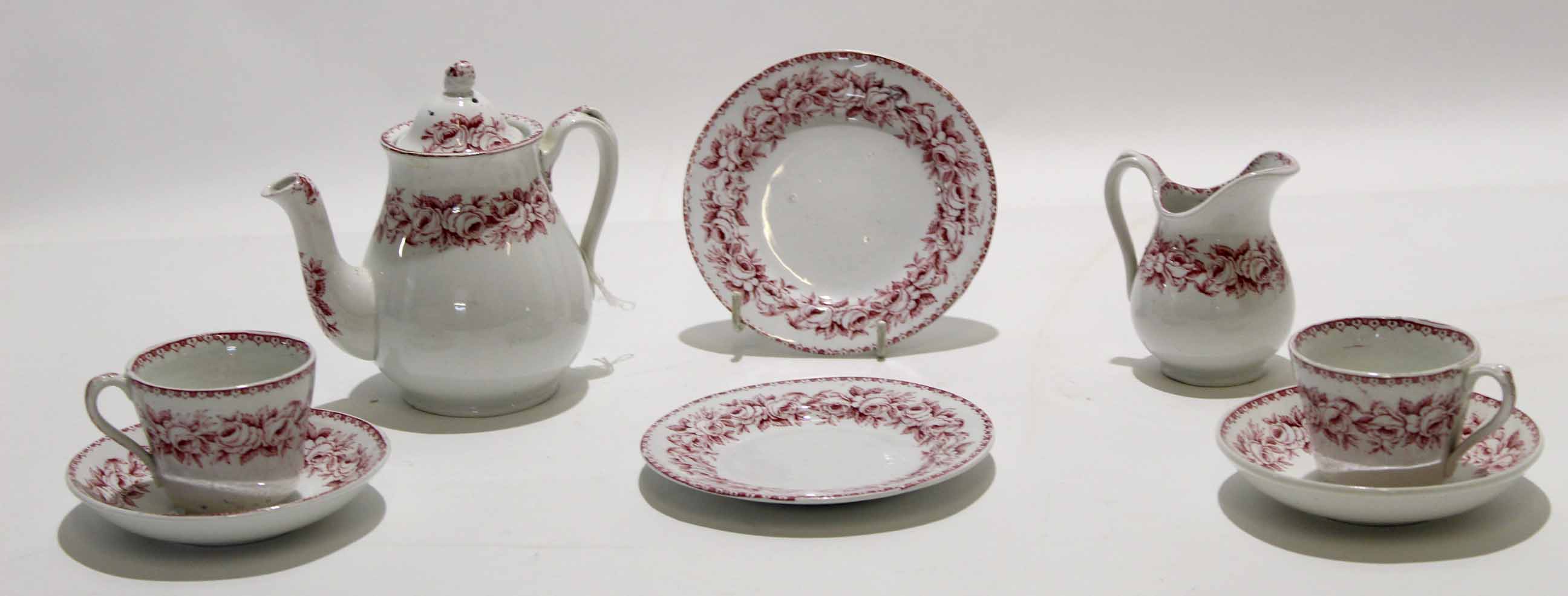 Late 19th century miniature tea set comprising tea pot and milk jug and two cups and saucers, and