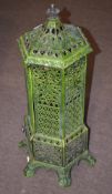 Late 19th century French green painted cast metal stove of hexagonal form, 90cm high