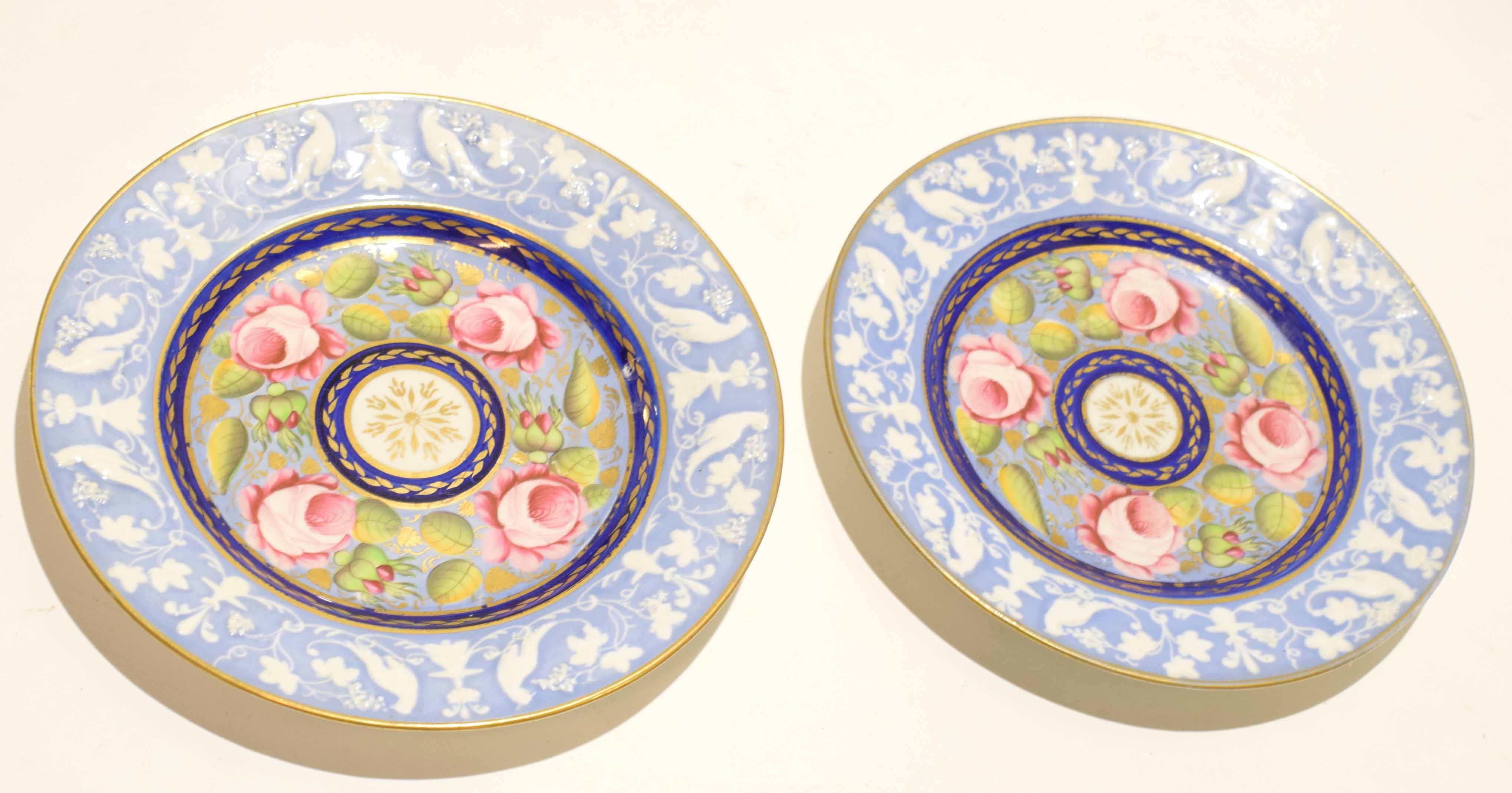 Two early 19th century Newhall plates the centres with painted flowers within borders with