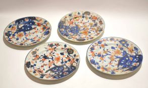 Group of four 18th century Chinese blue and white plates with overglaze decoration in iron red and