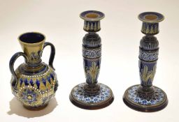 Pair of Doulton Lambeth candlesticks modelled with relief floral decoration and a further Doulton