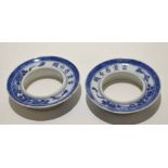 Two Chinese porcelain cup or beaker holders with a blue and white design and Chinese script around