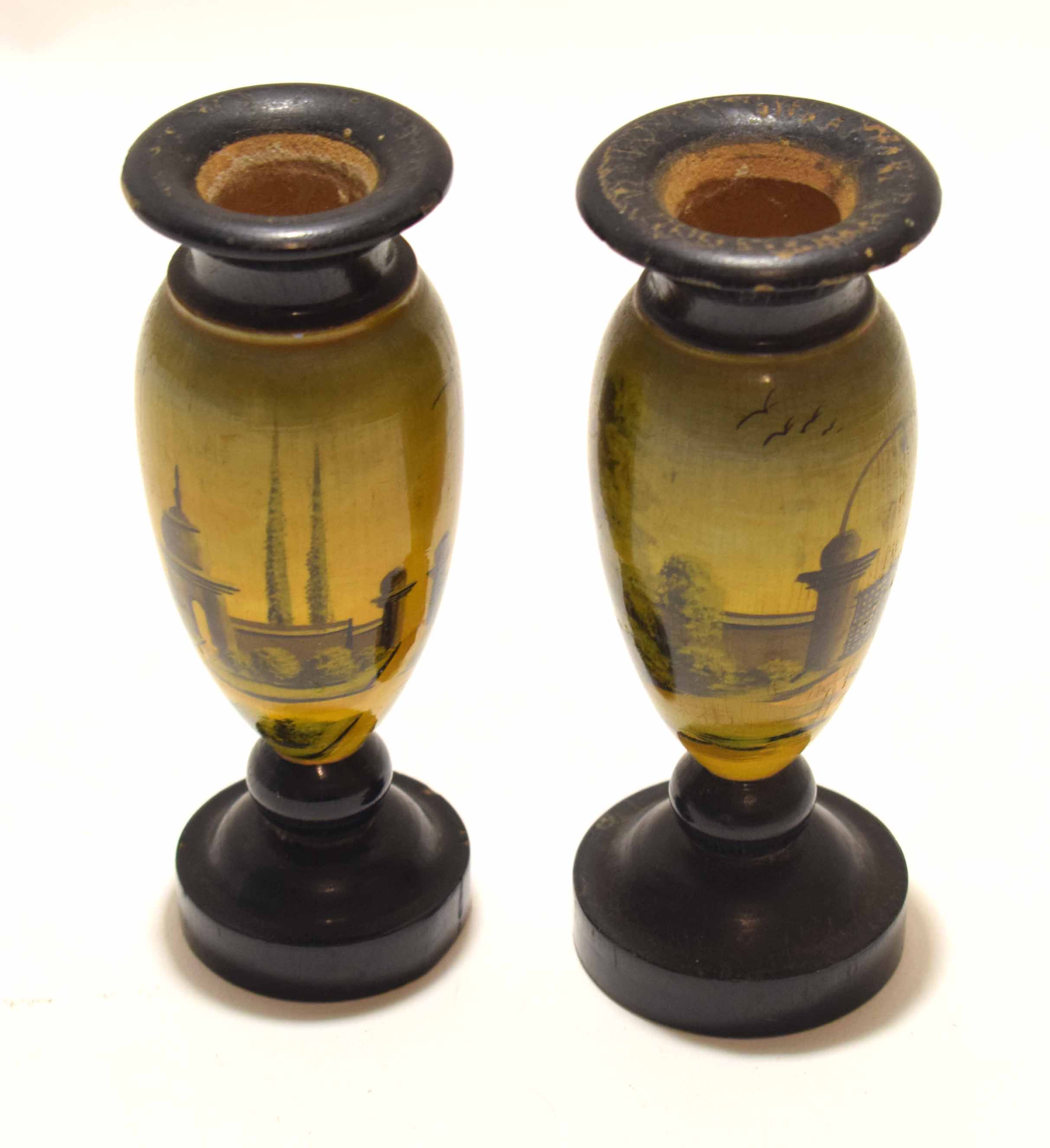 Pair of treen vases painted with garden scenes of flowers and trees on a painted yellow and green