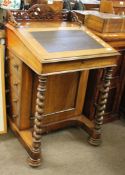 19th century rosewood Davenport with scroll carved fretwork pediment, lifting lid below enclosing
