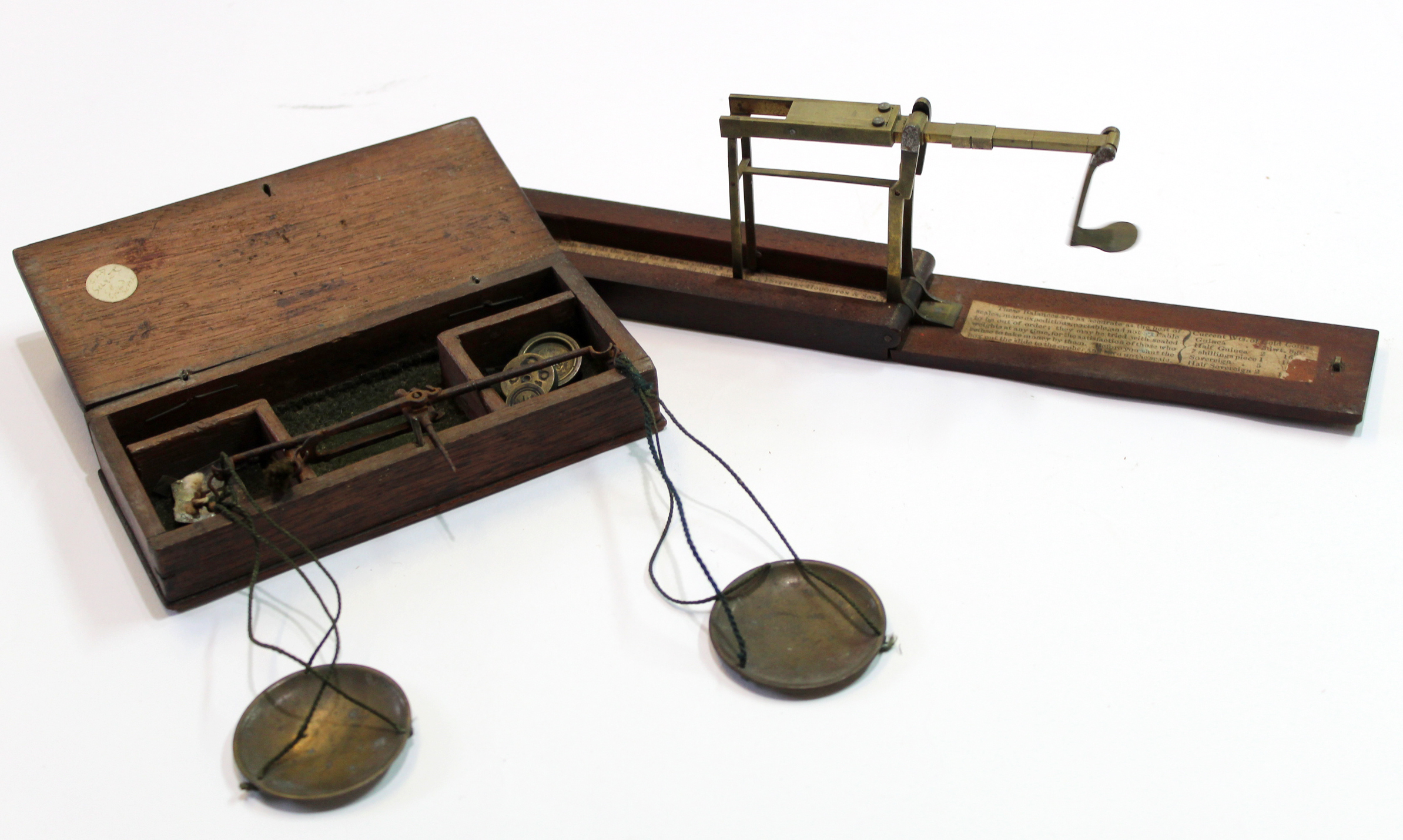 Weighing machine for coinage in small wooden box, together with a set of scales and small weights in
