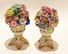Pair of mid-19th century Derby vases, modelled with flowers in relief standing on four gilt feet,