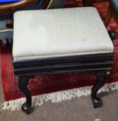 Ebonised framed adjustable piano stool, of rectangular form raised on cabriole supports of peg feet,