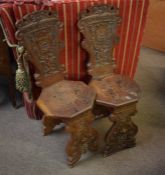 Pair of oak carved hall or turner's chairs, the backs carved with armorials and with initials TVSG