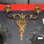 Gilt metal two-branch wall sconce with central rams head mount, 40cm wide