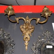 Gilt metal two-branch wall sconce with central rams head mount, 40cm wide