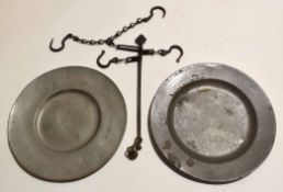 Two pewter plates, stamped to base, together with a chain finger measuring scale, 24cm diam (3)