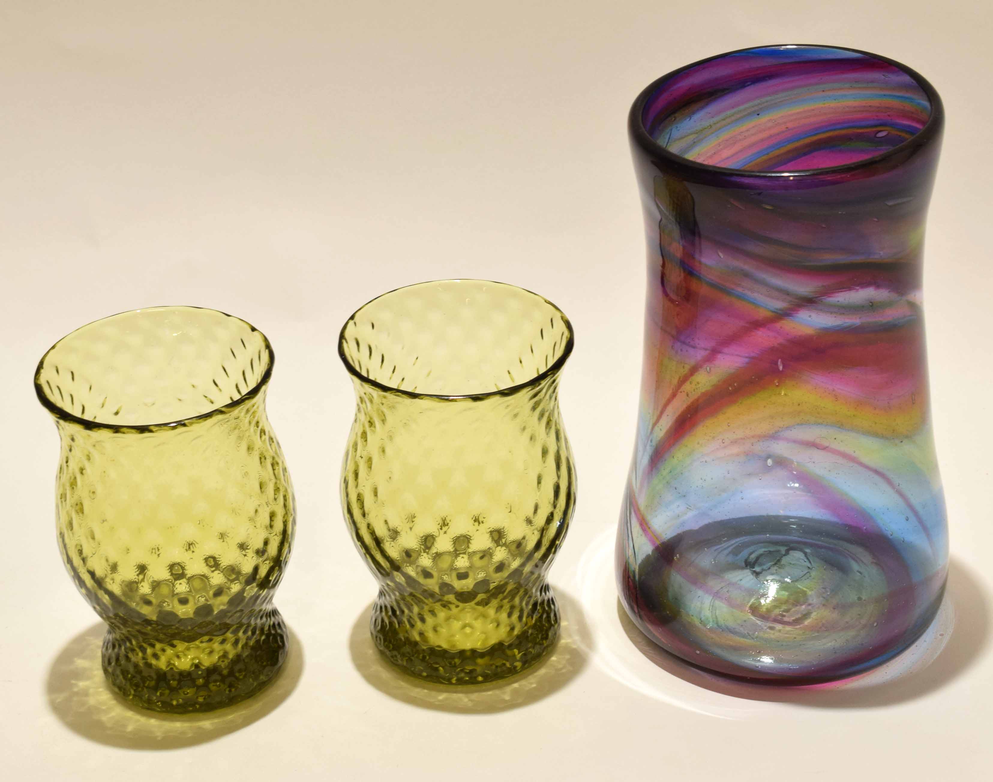 Pair of green glass vases and a large Art Glass baluster vase with streaked purple design, 24cm high