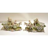 Pair of Continental porcelain figures of cows being led by a boy and a girl with carts, standing