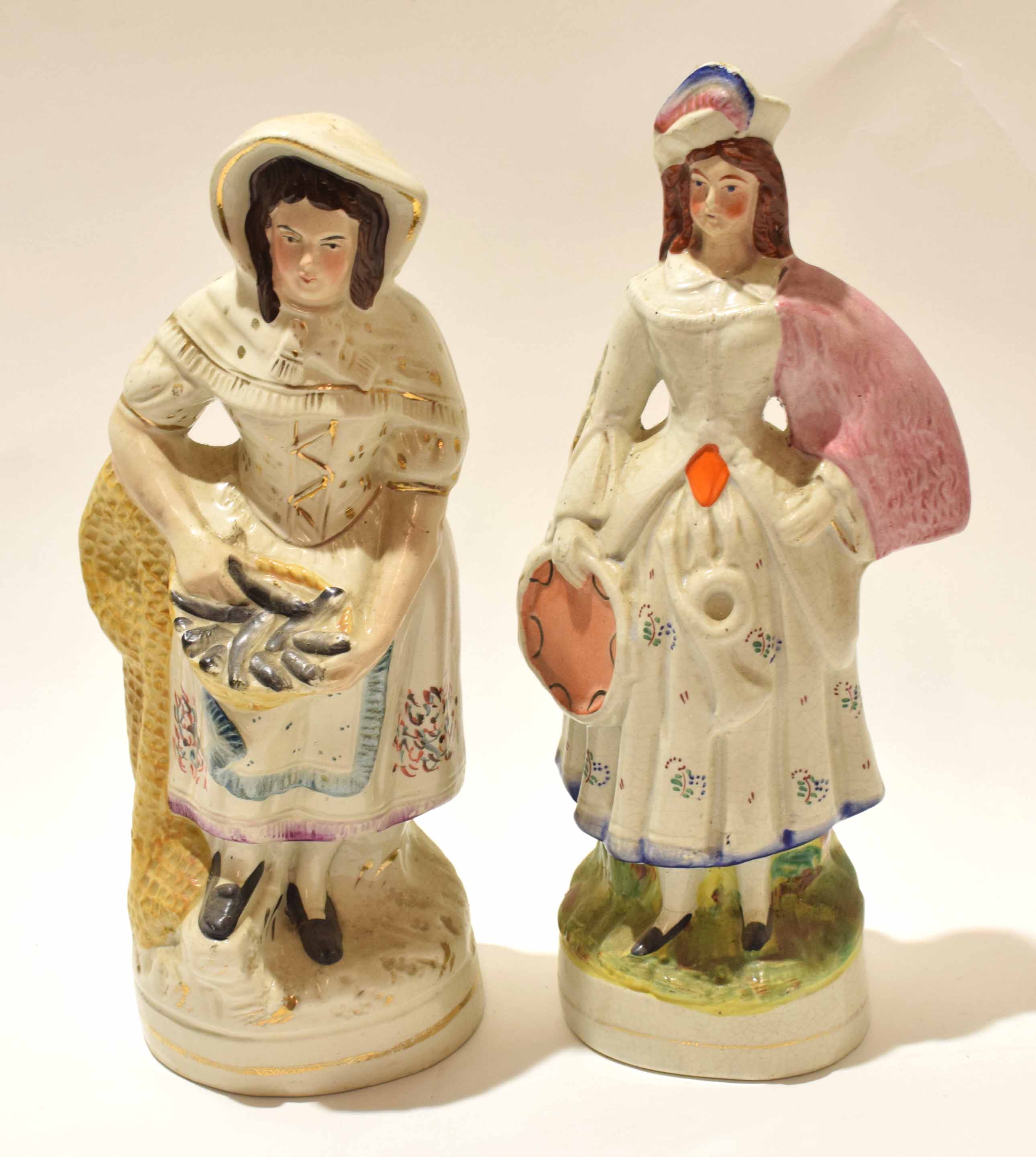 Two large Staffordshire figures, one of a fish seller, the other of a musician, 34cm high (2)