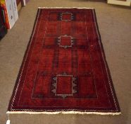 Modern Shiraz carpet, central panel of geometric lozenges, two-gull border, mainly red and black