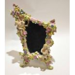 Late 19th century Continental porcelain easel back mirror, the frame with flower encrusted design