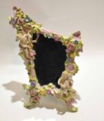 Late 19th century Continental porcelain easel back mirror, the frame with flower encrusted design