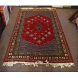 Modern Caucasian style carpet, central panel with geometric lozenge within four gull border, red,