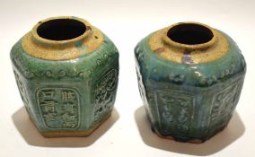 Two Oriental pottery vases of faceted form with green glazed panels with floral displays and Chinese