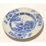 English Delft plate decorated with a pagoda within a border of floral sprays, 23cm diam