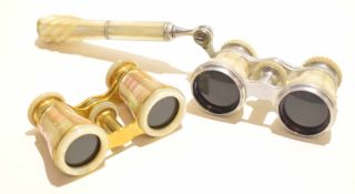 Pair of opera glasses with mother of pearl design, together with a further set and carrying