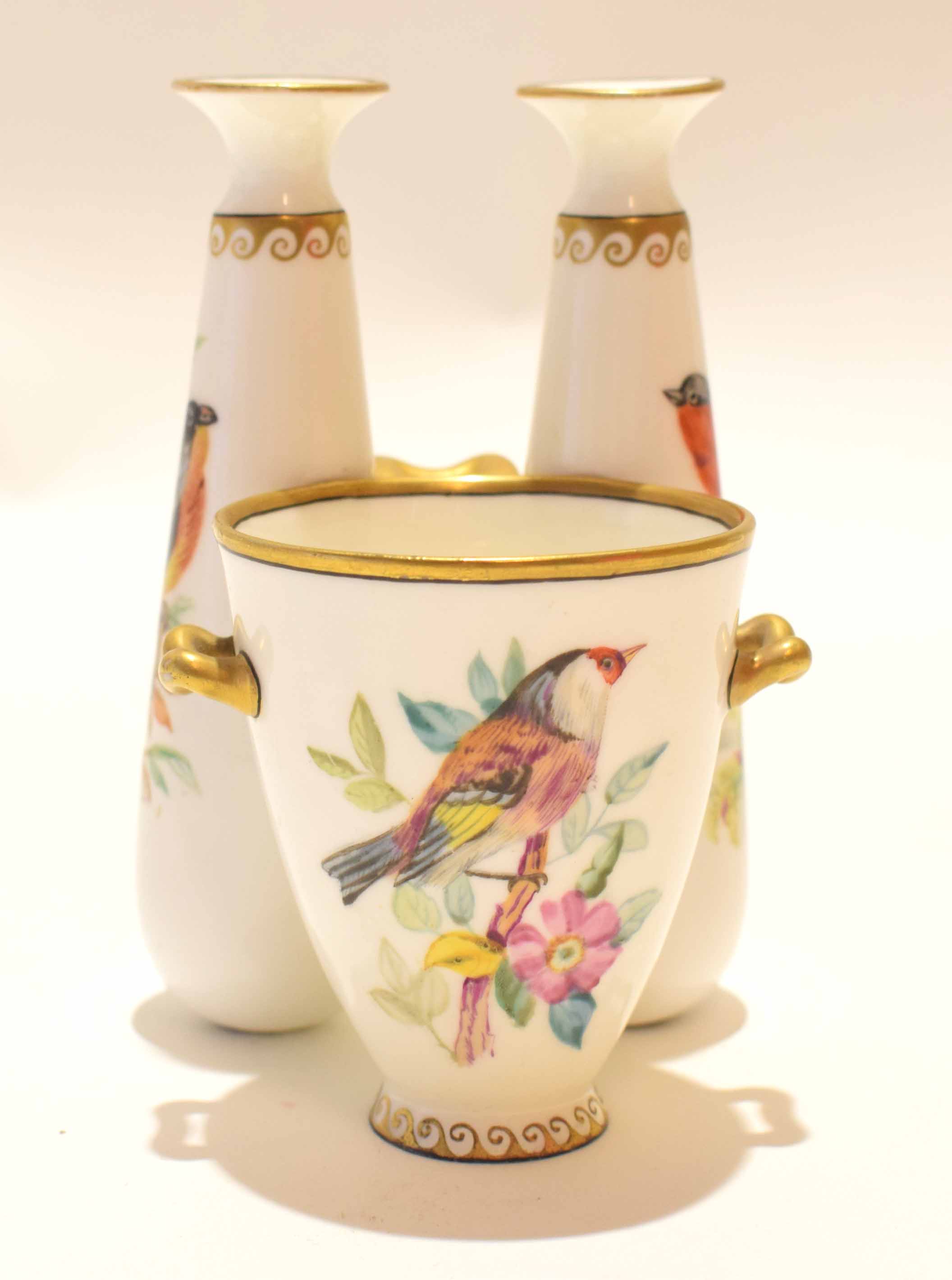 Mid-19th century Worcester spill vase decorated with birds, flanked by two tapering vases also