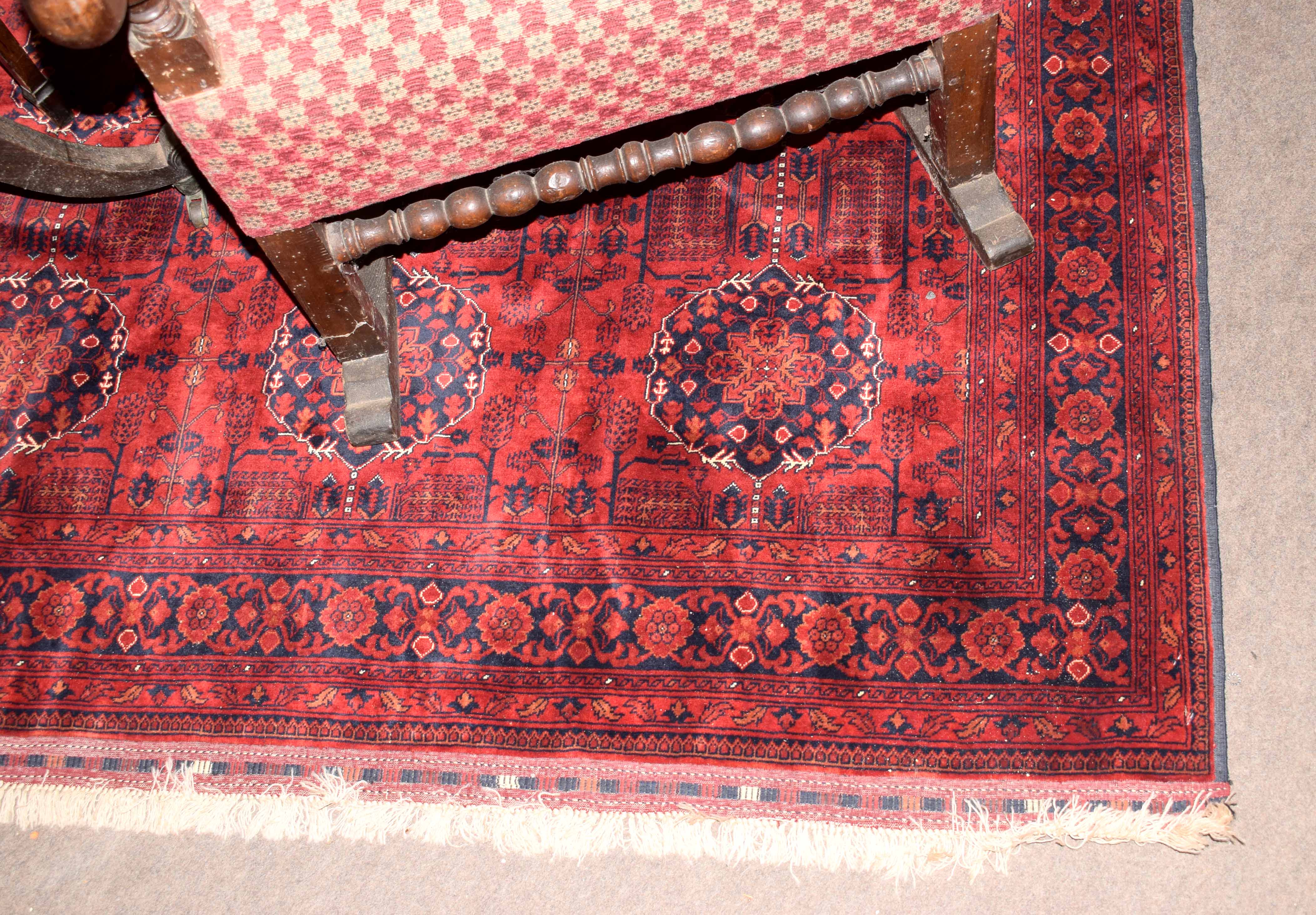 Caucasian wool carpet, central panel of floral lozenges, multi-gull border, mainly red field, - Image 2 of 3