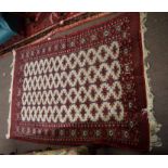 Caucasian rug, central panel of geometric designs on a beige field within a red multi-gull border,