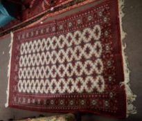 Caucasian rug, central panel of geometric designs on a beige field within a red multi-gull border,