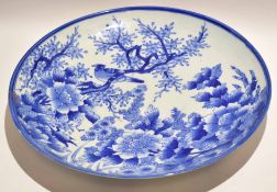 Large Japanese porcelain charger decorated in blue and white design of birds in branches amongst