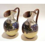Pair of Doulton Lambeth ewers, decorated with stylised fruit by Bessie Newbury, 20cm high