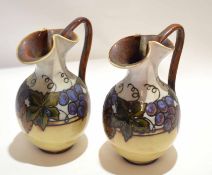 Pair of Doulton Lambeth ewers, decorated with stylised fruit by Bessie Newbury, 20cm high