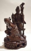 Large Chinese wooden carving of a couple, the man holding a staff, the lady with a sword standing