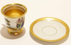 19th century Paris porcelain cup and saucer, the cup painted with a couple in a landscape within