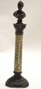 Early 20th century thermometer with mercury tube, fixed to a plinth with metal sculpture above of a