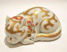 Oriental porcelain model of a sleeping cat with a collar in polychrome enamels and a gilt design