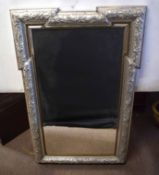 Large silvered framed overmantel mirror, possibly former picture frame, the frame embossed with