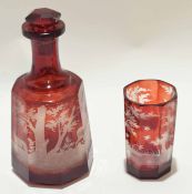 Bohemian style ruby glass decanter and octagonal shaped beaker, the glass finely engraved with a