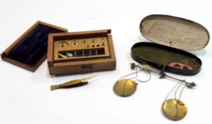 Wooden box containing a small quantity of weights and scales in oval metal box (2)