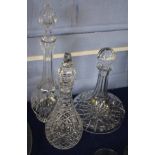 Three heavy cut glass decanters, one ship's decanter and two further baluster decanters with