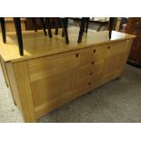 GOOD QUALITY MODERN OAK SIDEBOARD FITTED CENTRALLY WITH SINGLE CUPBOARD DOOR FORMED AS FOUR DRAWERS,