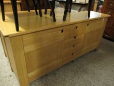 GOOD QUALITY MODERN OAK SIDEBOARD FITTED CENTRALLY WITH SINGLE CUPBOARD DOOR FORMED AS FOUR DRAWERS,